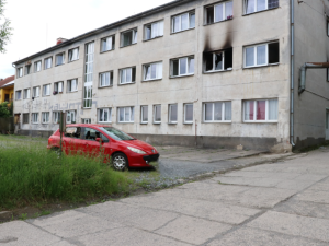 Ze msty muž zapálil ubytovnu, kladivem zdemoloval auto a ohrozil životy 68 lidí