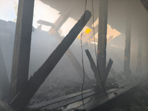 Při požáru bytovky se zranili dva hasiči a obyvatel domu, škoda je přes milion