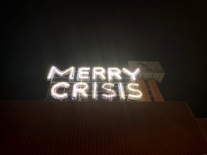 Záhadný svítící nápis MERRY CRISIS nastolil otázku a vyvolal bouřlivou diskusi