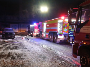 Plameny pohltily dům, který slouží i jako sklad nábytku. Hasiči museli rozřezat mříže