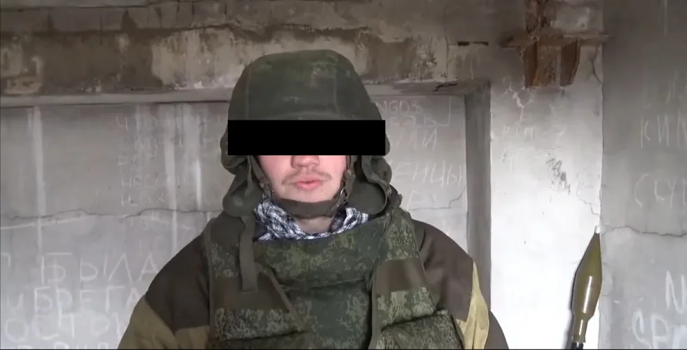Foto z videozáznamu, němž Lukáš N. v uniformě a se zbraněmi vypráví ruským novinářům kde, jak a proč v Doněcku a Luhansku bojuje.