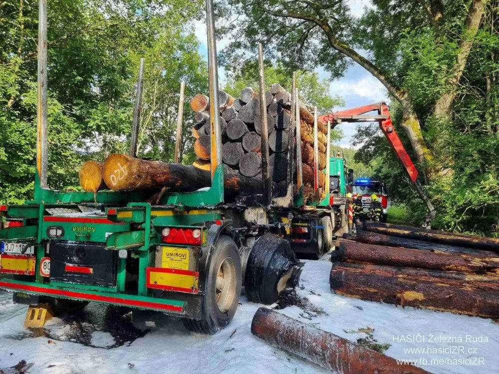 Kamion s nákladem dřeva náhle vzplál, statečný řidič dokázal hydraulickou rukou vyložit většinu hořících klád