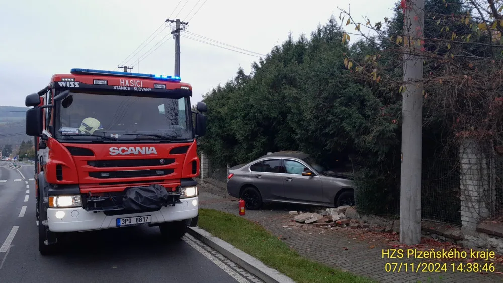 Řidička vletěla s luxusním BMW na chodník, kde zdemolovala hradbu a oplocení u domu