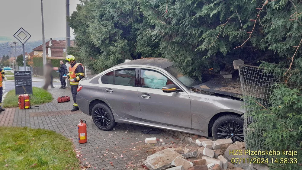 Řidička vletěla s luxusním BMW na chodník, kde zdemolovala hradbu a oplocení u domu