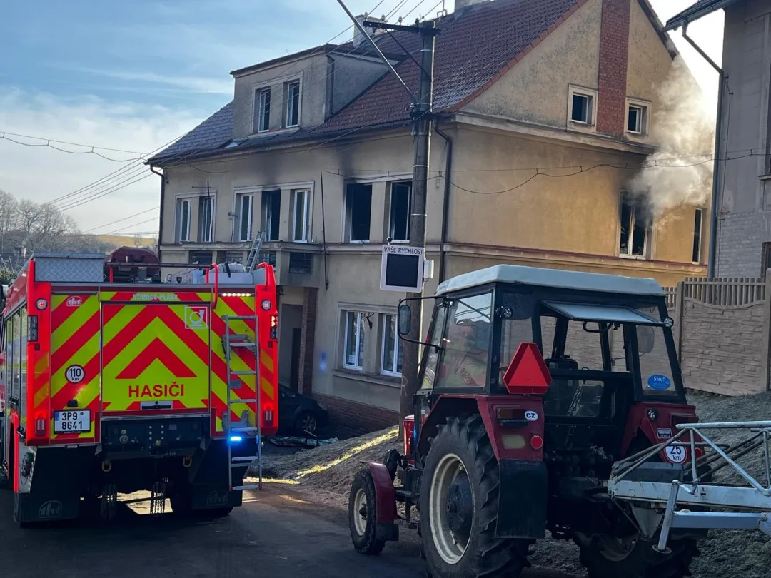 Hasiči zachraňovali pomocí žebříku nájemníky domu, které tam uvěznil požár jednoho bytu