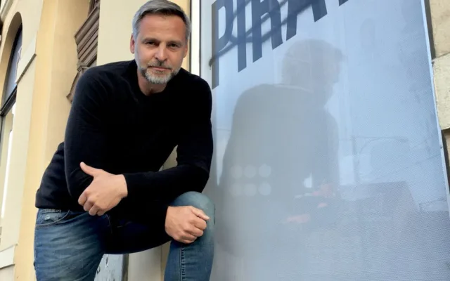 Pirátský zastupitel Pavel Bosák u poničené výlohy pirátského centra
