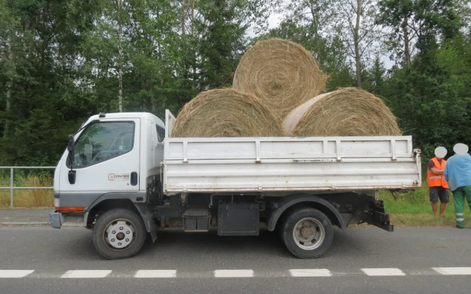 Řidič nedostatečně upevnil náklad, balík slámy spadl na projíždějící auto.