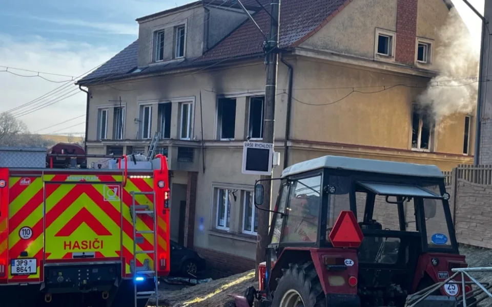 Hasiči zachraňovali pomocí žebříku nájemníky domu, které tam uvěznil požár jednoho bytu